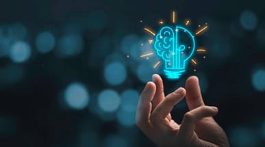 Hand holding a glowing lightbulb symbolizing smart CRM business solutions