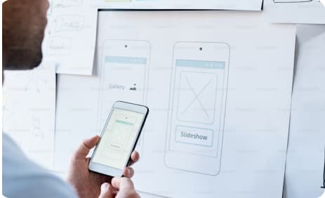 UX wireframes on phone and board